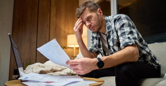 Man Stressed Over Bills at Home