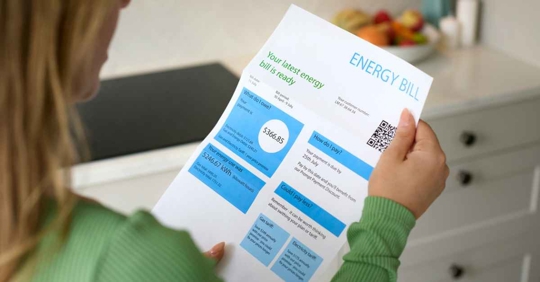 Close Up Of Woman Opening Energy Bill